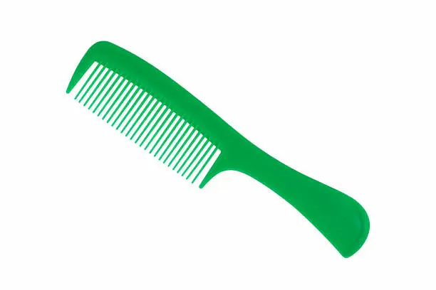 Photo of Close up photography of beautiful clean empty green color new plastic comb and equipment of hairdresser isolated on white background.
