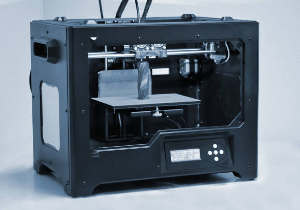 istock 3D printer works and creates an object from the hot molten plastic 1339305457