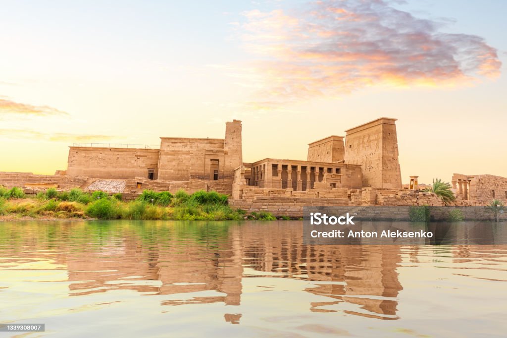 Temple of Isis on Philae Island at sunset, view from the Nile, Aswan, Egypt Temple of Isis on Philae Island at sunset, view from the Nile, Aswan, Egypt. Aswan - Egypt Stock Photo
