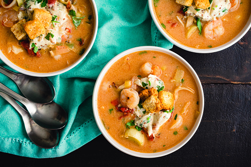 Seafood bisque topped with crab salad, croutons, and parsley