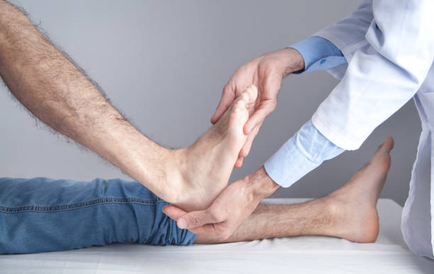 istock Caucasian doctor examining patient foot. 1339311775