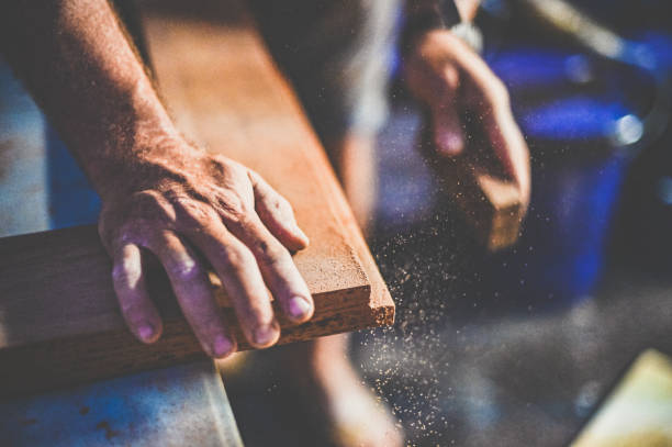istock Close up of a mans hands sanding a woodworking diy project 1339311876