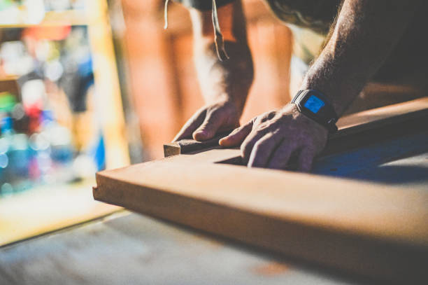 istock Close up of a mans hands sanding a woodworking diy project 1339311996