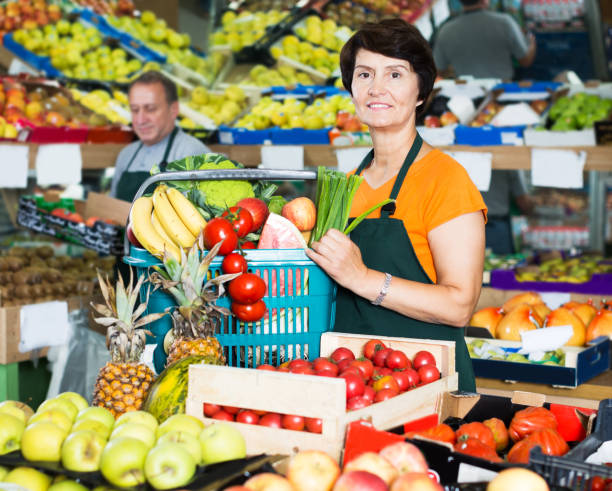 istock Saleswoman with basket in store 1339312005