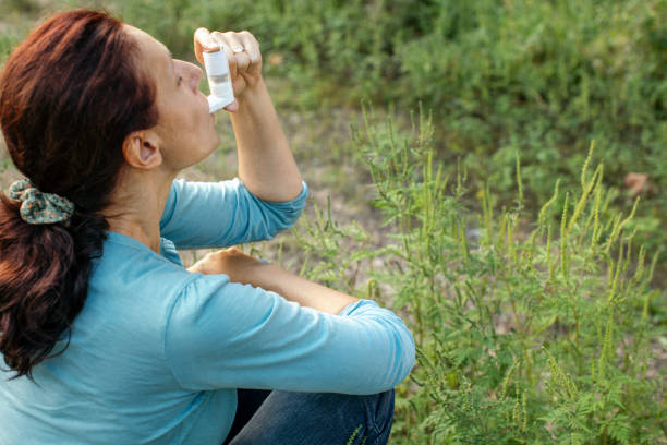 istock Woman sitting outdoors and suffering from pollen allergy 1339312732