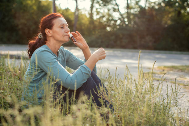 istock Woman sitting outdoors and suffering from pollen allergy 1339312913