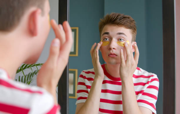 istock A young  guy does a morning beauty routine standing in front of mirror wearing cleaning eye patches on face 1339313534