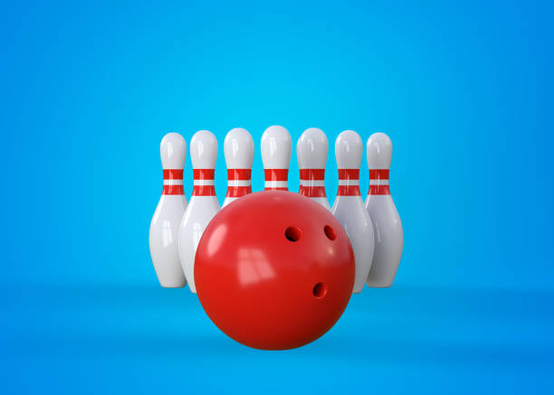 istock White bowling pins in form of triangle and bowling ball on blue background 1339313545