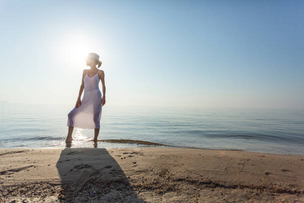 istock Beautiful elegant woman on the beach 1339314983
