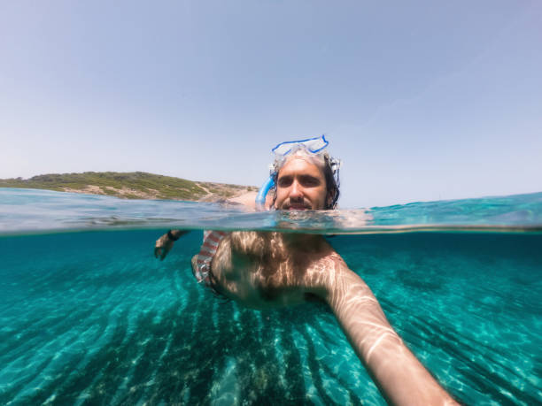 istock A man is taking a selfie while he's swimming in the sea 1339317520