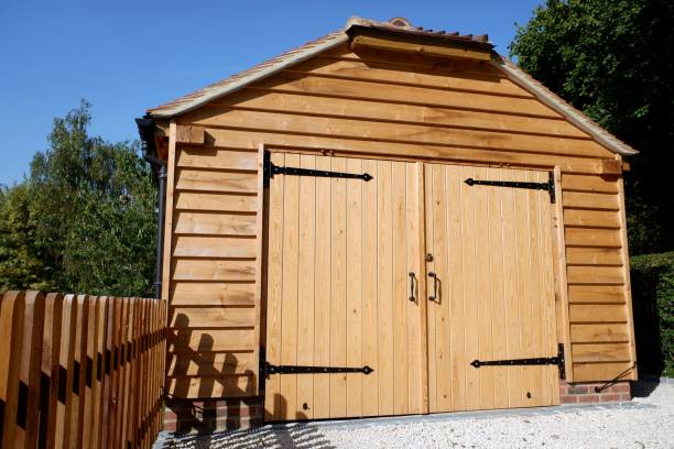 istock Pine log garage with lockable double wooden doors and picket fence 1339322795