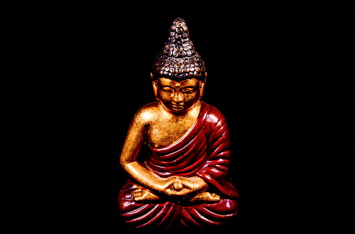 Oriental Buddist Statue Isolated on a Black Background