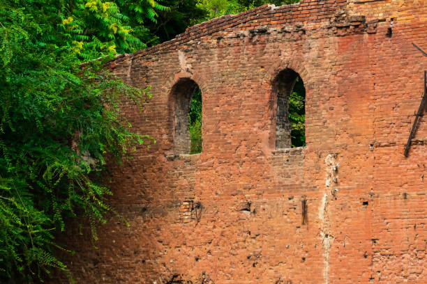 istock Old red brick fortress wall with windows 1339325733