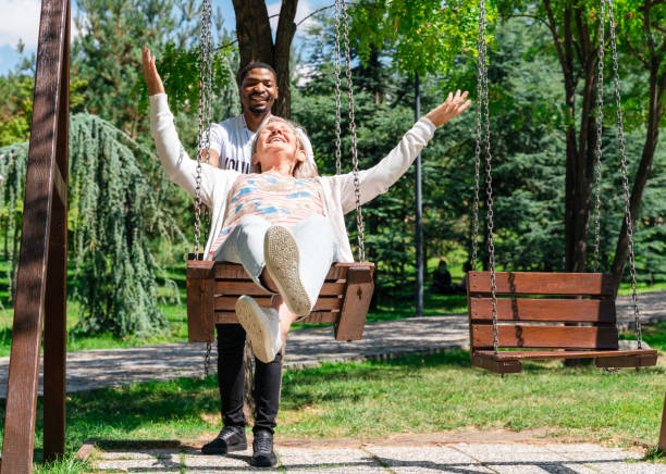 istock volunteer pushing senior women on swing 1339328459