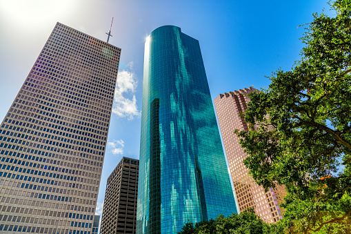 Generic all glass office building set against blue sky on nice day