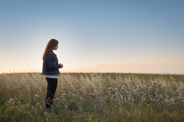 istock Young woman in prayer 1339332568