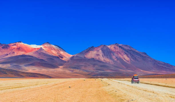 Road in the desert and mountain landscape in the Altiplano of Bolivia stock photo