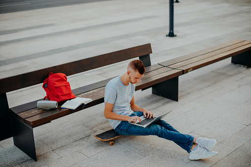 College student sitting outside on bench
