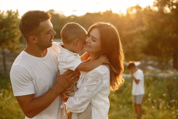 istock Cute family playing in a summer field 1339334831