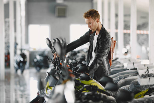 istock Handsome man choosing a motorcycle to buy 1339335783