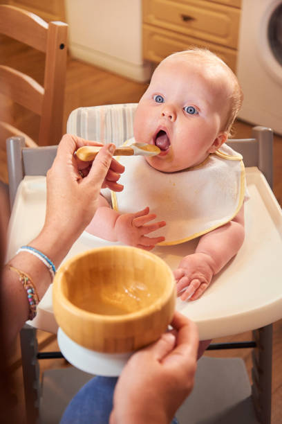 istock Baby girl at meal time 1339336588