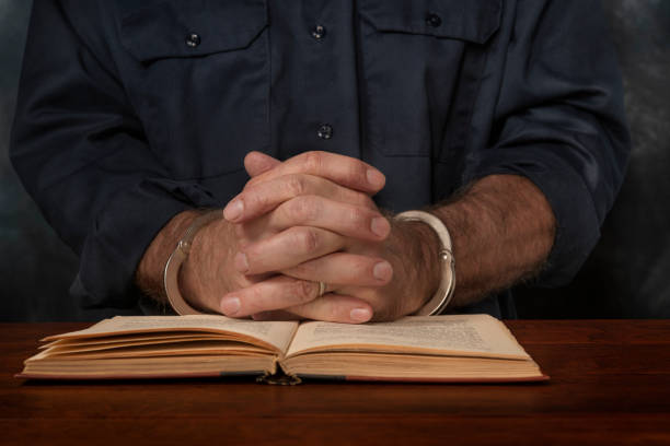 istock Criminal reads a law book 1339340250