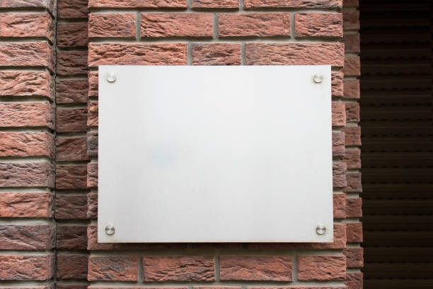 istock Mockup template with blank metallic board on street building facade 1339341051