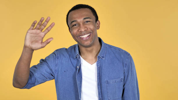 istock Young African Man Inviting Customers with Both Hands Isolated on Yellow Background 1339341604