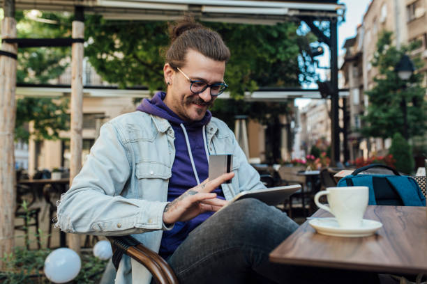 istock Young man enjoying his coffee break and shopping online 1339342322