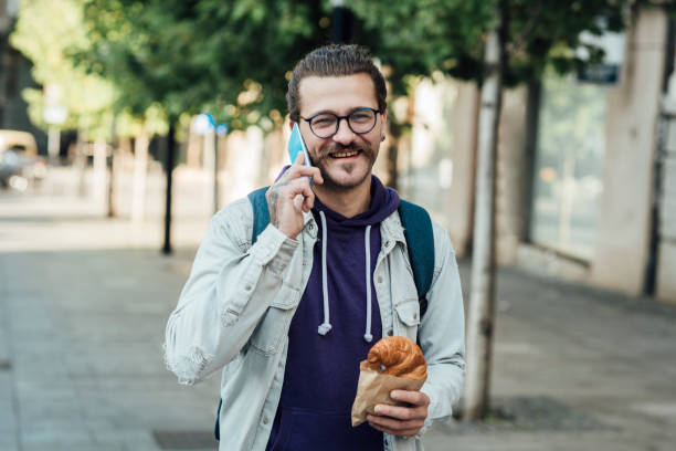 istock Portrait of a student having breakfast and telephoning on the move 1339342364