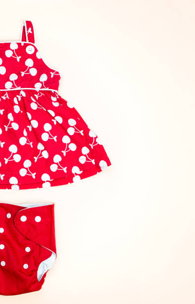 istock Red dress and reusable diaper on light background 1339349003