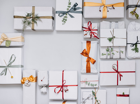 Directly above photo of wrapped xmas gifts at desk with copy space