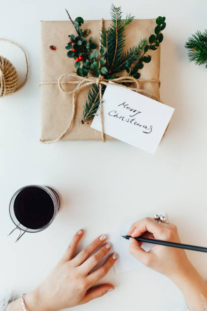 istock Woman Writing Greeting Card For Presents 1339350504