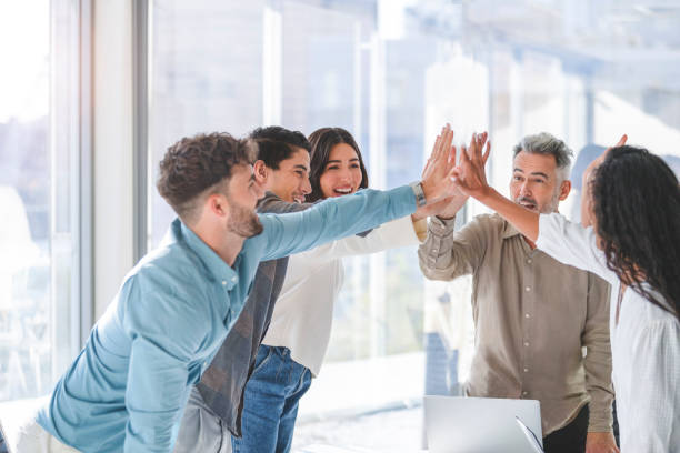 istock Business team celebrating success with a high five. 1339357904
