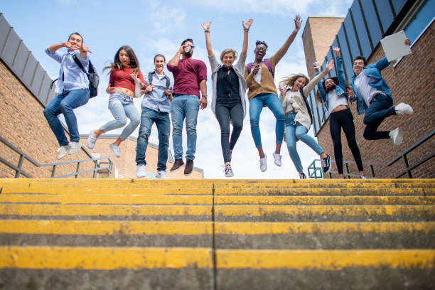 istock High school students jumping in the air 1339358389