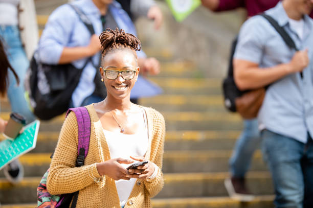 istock Smiling female African American university student on campus 1339358396