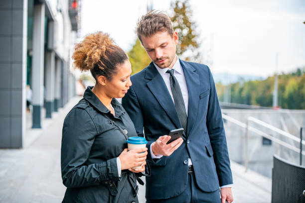 istock Business Associates Checking Smart Phone on Coffee Break 1339362582