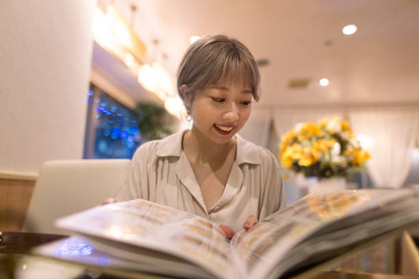 istock Young woman looking at menu in Asian restaurant 1339365170