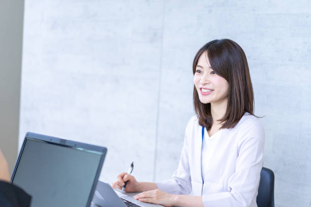 Career woman having fun at work Career woman having fun at work japanese ethnicity stock pictures, royalty-free photos & images