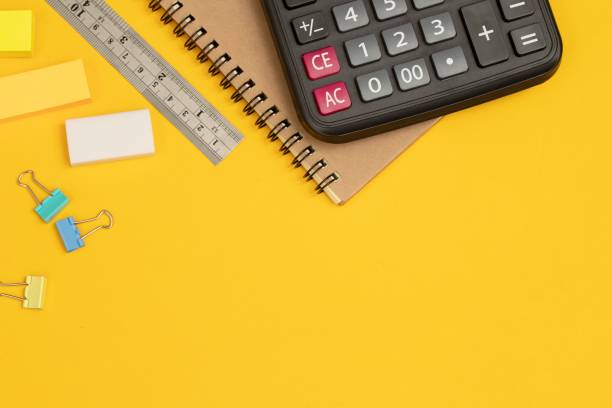 istock calculator and writing equipment on yellow background 1339375452