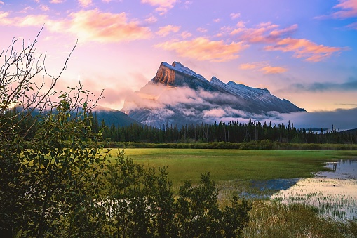 A bright cloudy morning sky over Vermilion Lakes in Banff National Park.
