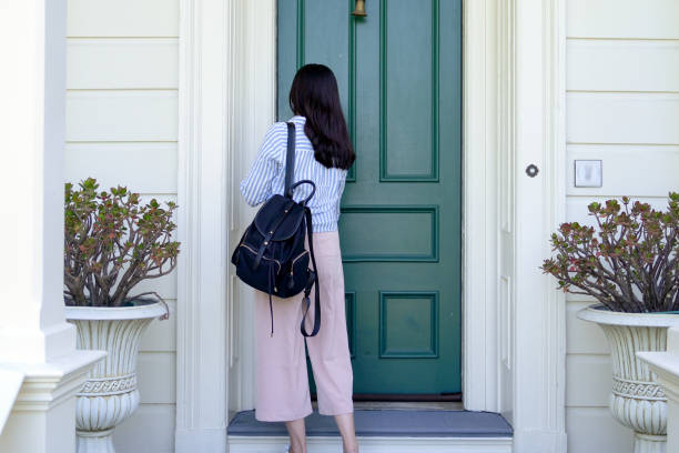 girl back to home using key opening door