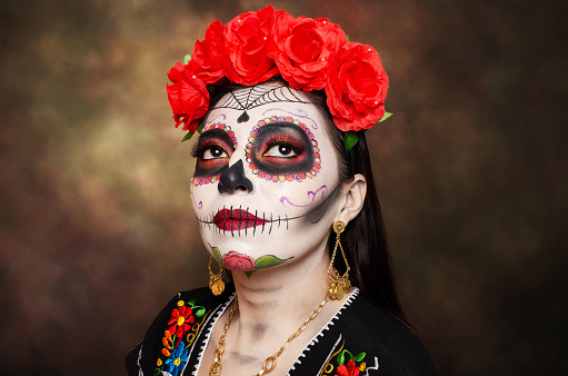 Portrait of a woman with catrina makeup. Catrina, a character in Mexican culture related to the Dia de Muertos.