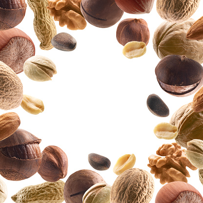 Large collection of different nuts on a white background.