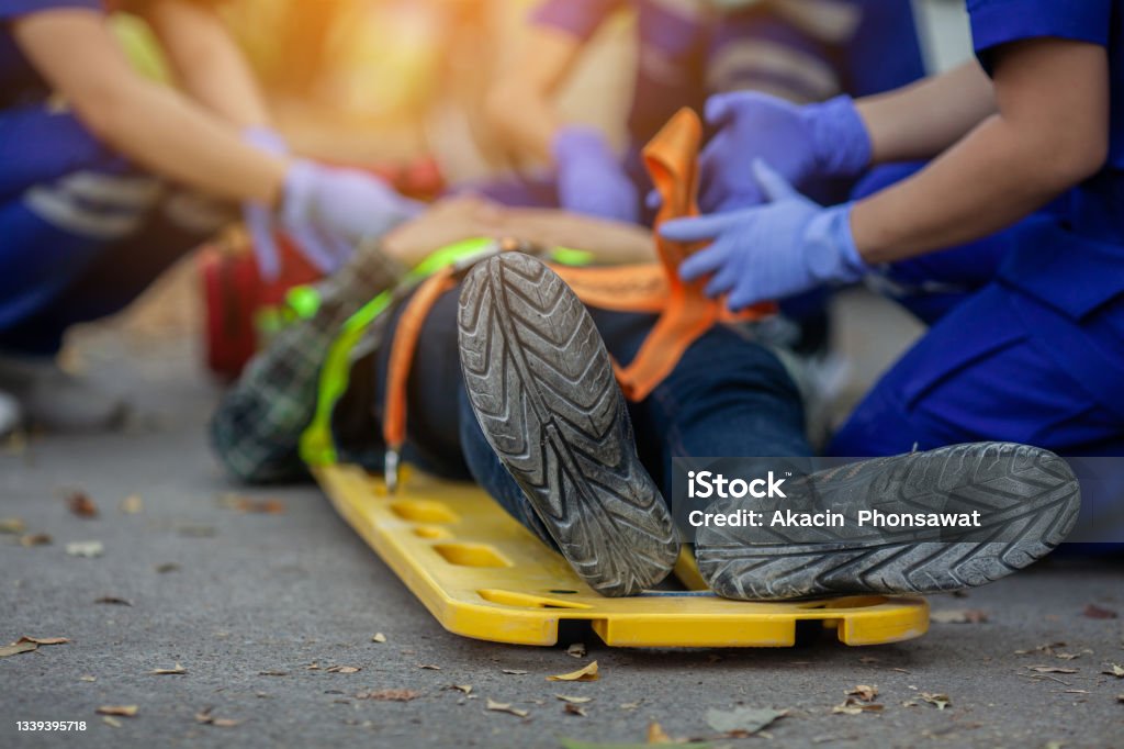 Team paramedic firs aid accident on road. Ambulance emergency service. Selective focus shoe . Team paramedic firs aid accident on road. Ambulance emergency service. First aid procedure. Physical Injury Stock Photo