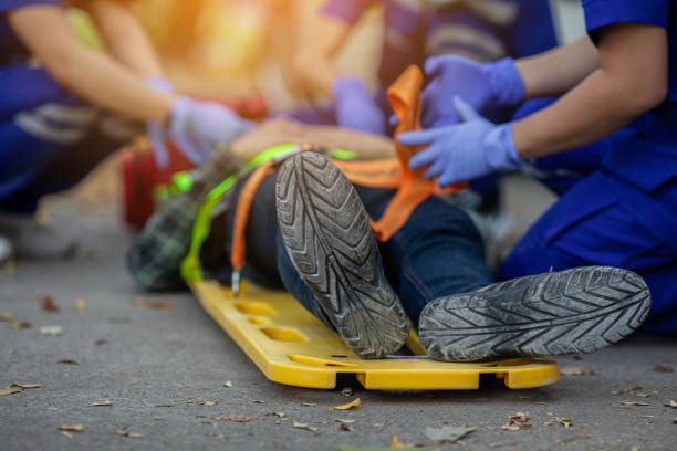 Team paramedic firs aid accident on road. Ambulance emergency service. Selective focus shoe . Team paramedic firs aid accident on road. Ambulance emergency service. First aid procedure. Construction Site accident stock pictures, royalty-free photos & images