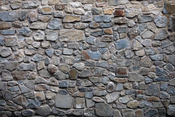istock Old wall of natural material from granite blocks for graphic designs 1339398655
