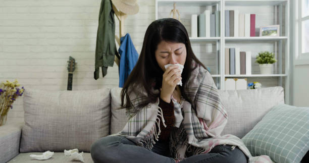 istock illness asian female sneezing running nose 1339399828