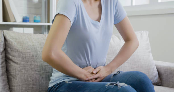 istock unrecognized ill asian lady holding stomach. 1339399907