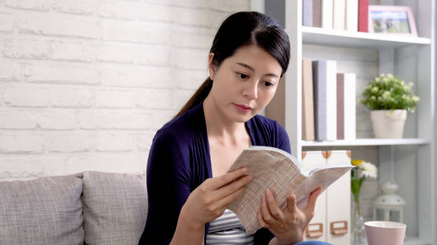 istock attractive young woman reading at home 1339402373